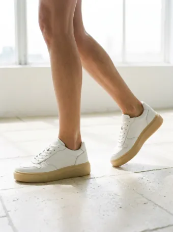 Leather sneakers — On a foot, at a walking angle